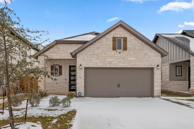 a front view of a house with garage