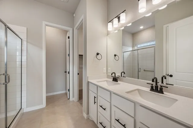 a bathroom with a double vanity sink mirror and double