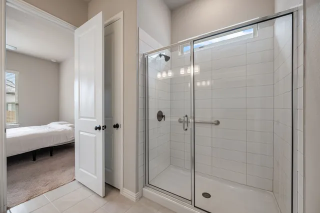a bathroom with a glass shower door and a sink