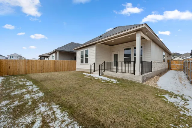 a view of a house with wooden fence