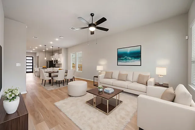 a living room with furniture and a wooden floor