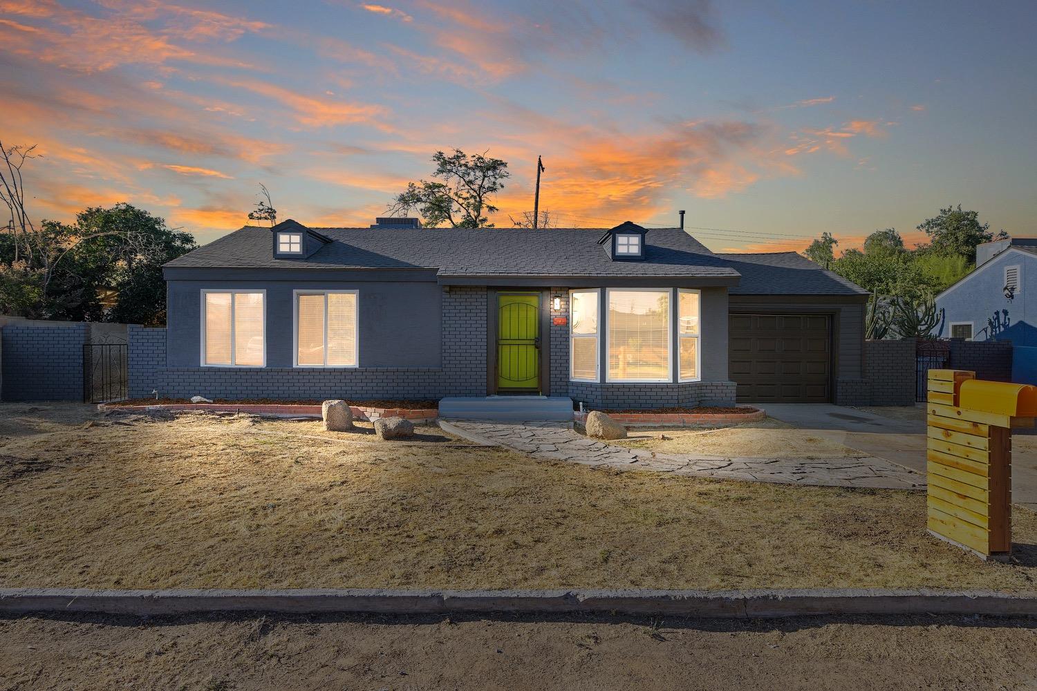 a front view of a house with garden