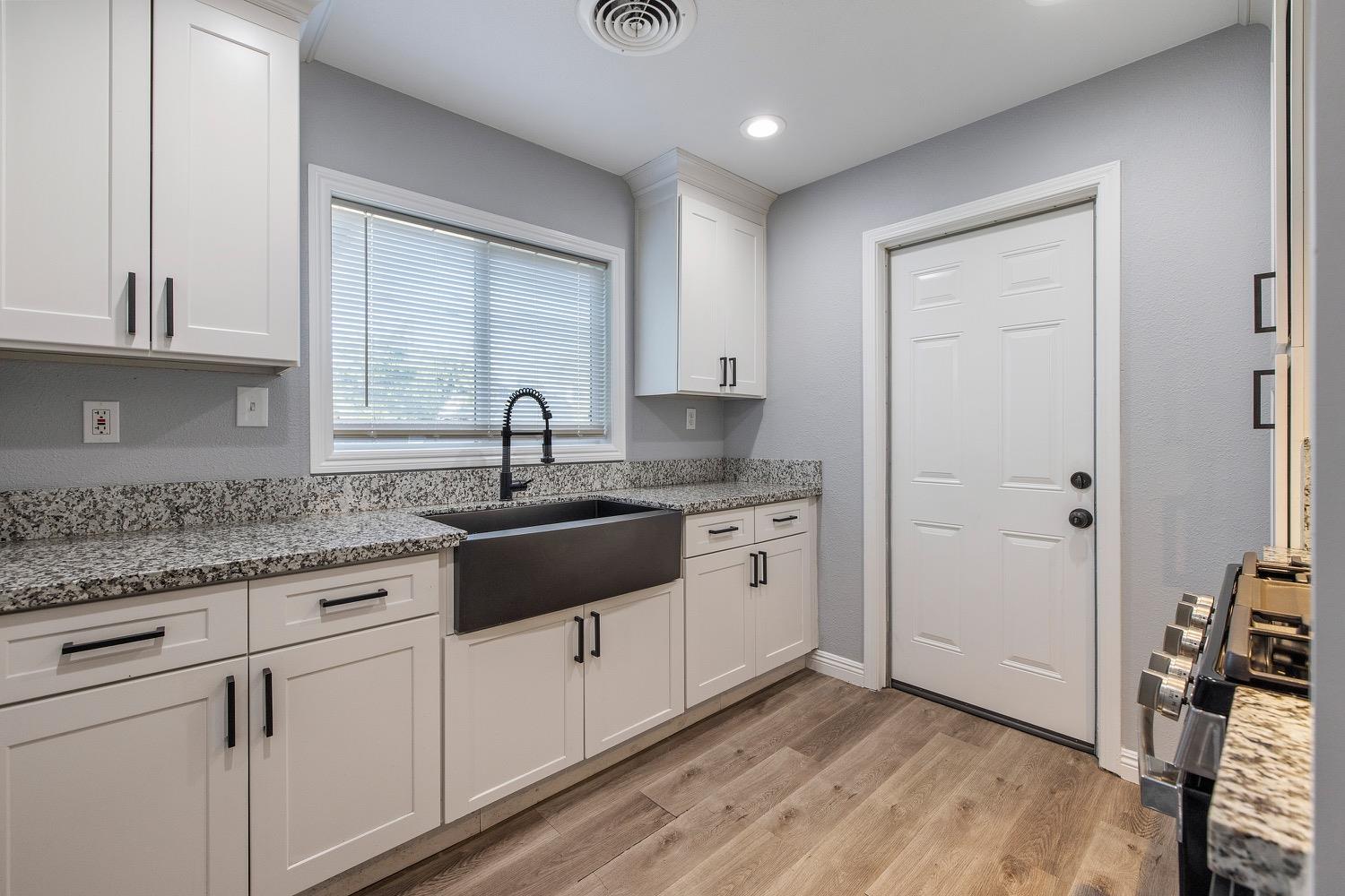 71 East Griffith Way Fresno, CA 93704 - Photo 14 of 35 a kitchen with stainless steel appliances granite countertop a sink and cabinets