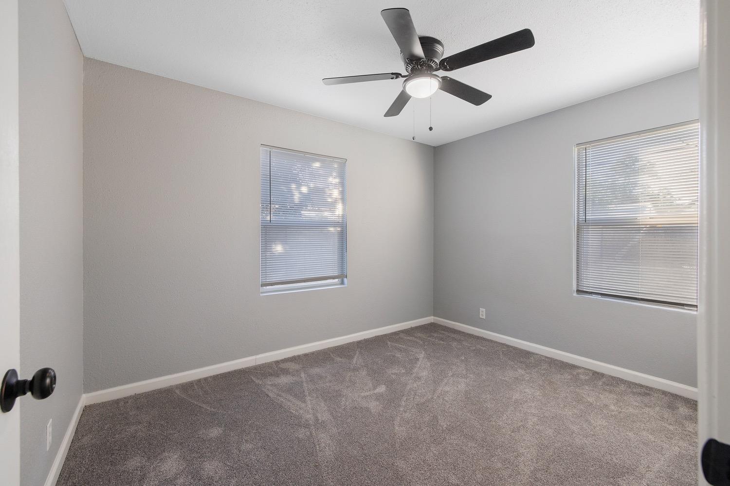 71 East Griffith Way Fresno, CA 93704 - Photo 20 of 35 an empty room with windows and fan