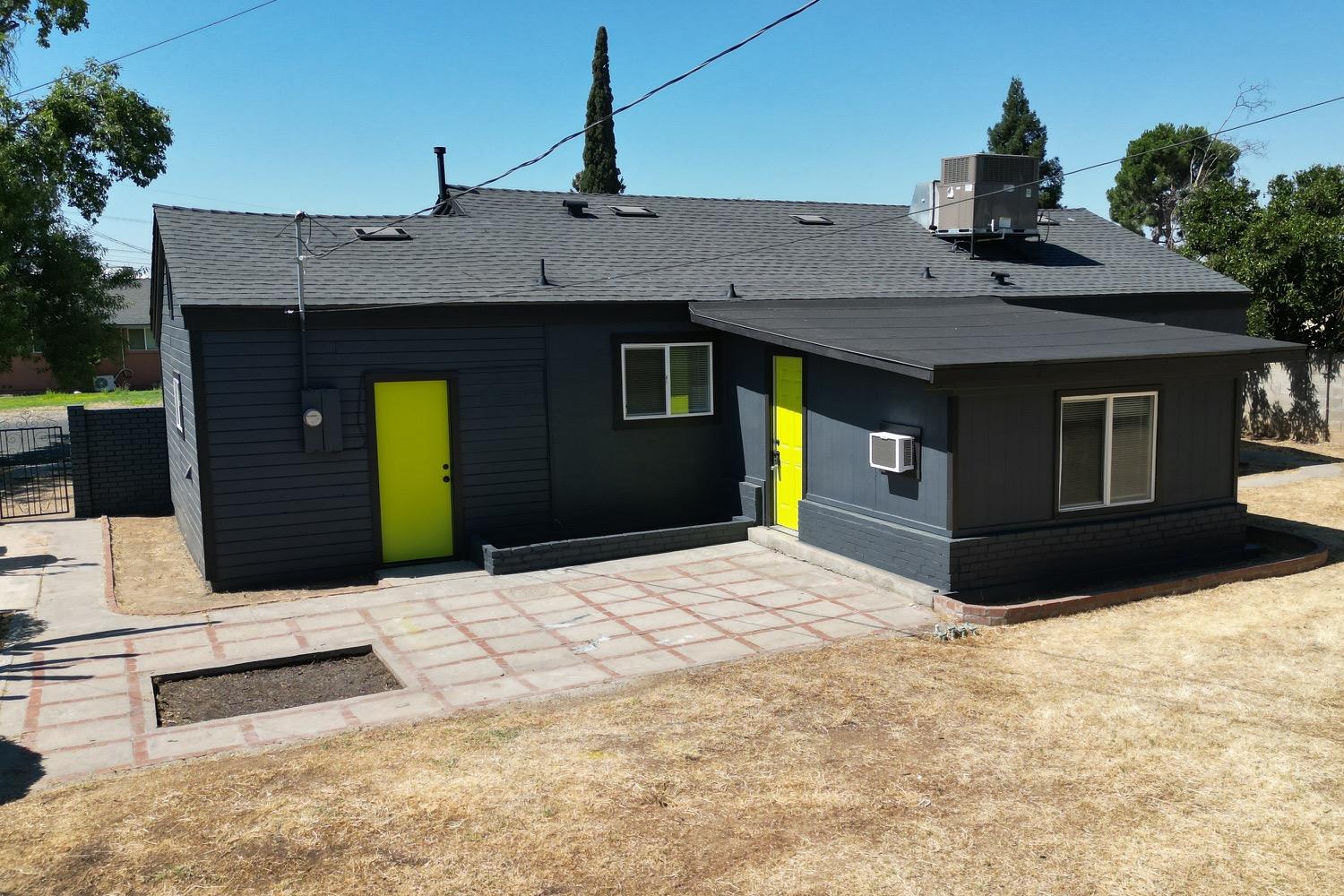 71 East Griffith Way Fresno, CA 93704 - Photo 25 of 35 a front view of a house with a yard