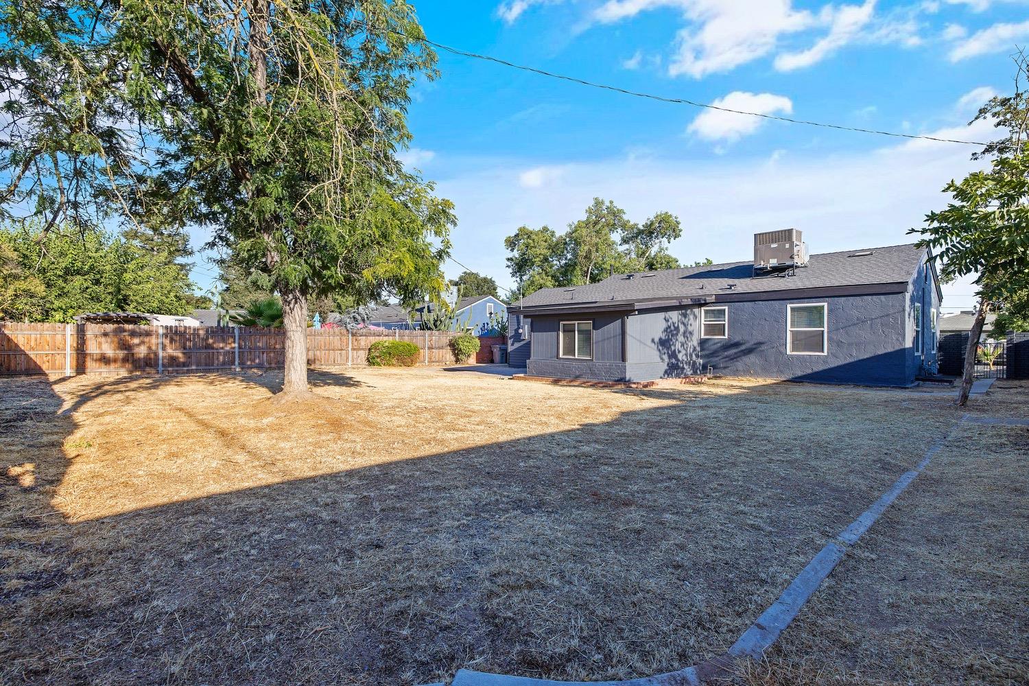 71 East Griffith Way Fresno, CA 93704 - Photo 29 of 35 a house with trees in front of it