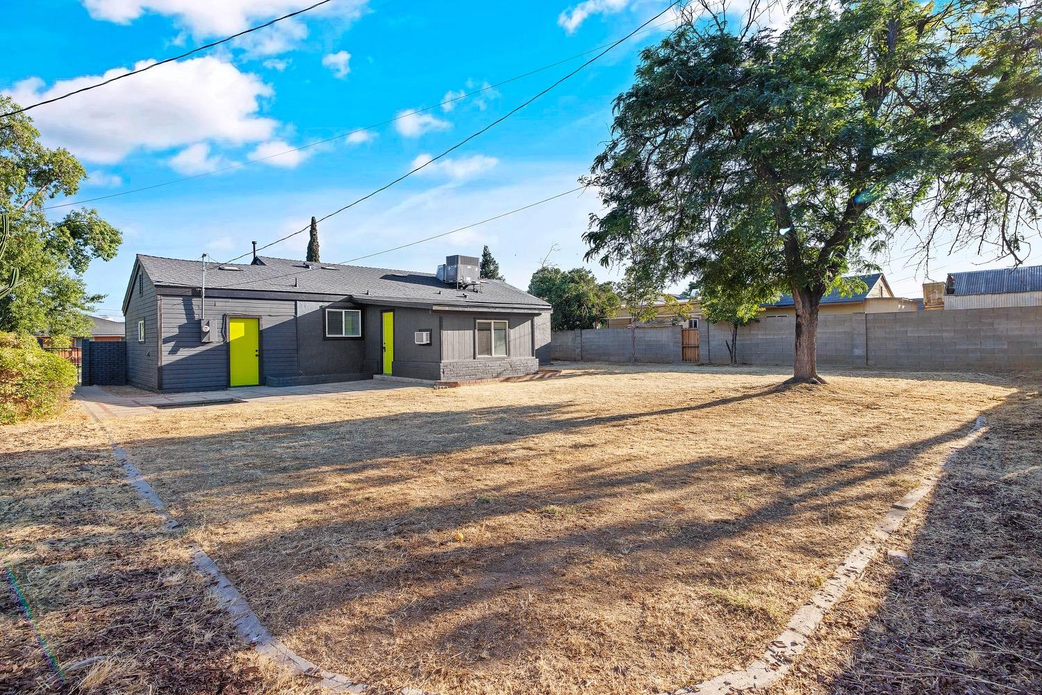 71 East Griffith Way Fresno, CA 93704 - Photo 30 of 35 a front view of a house with large trees