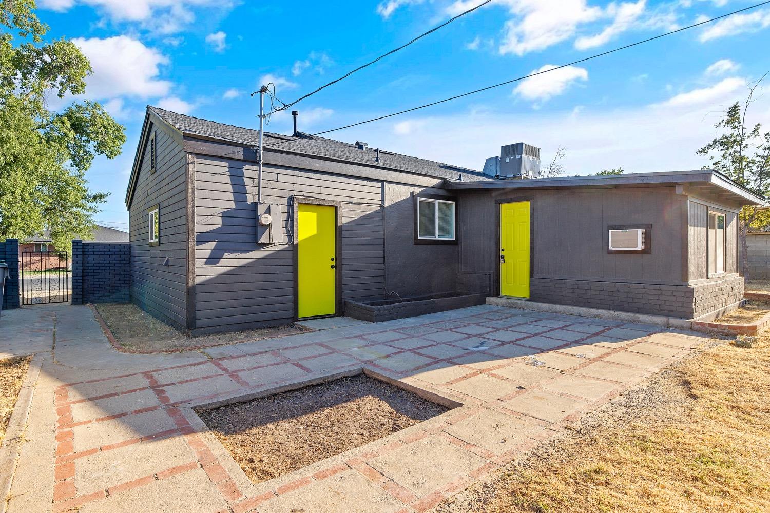 71 East Griffith Way Fresno, CA 93704 - Photo 31 of 35 a front view of a house with a yard