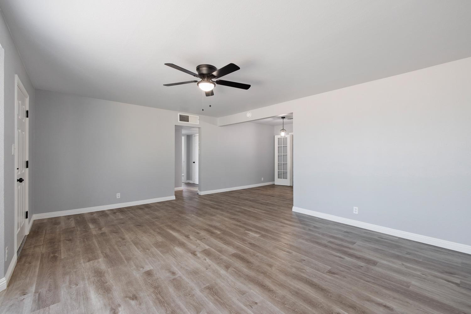 71 East Griffith Way Fresno, CA 93704 - Photo 6 of 35 a view of room with wooden floor and ceiling fan