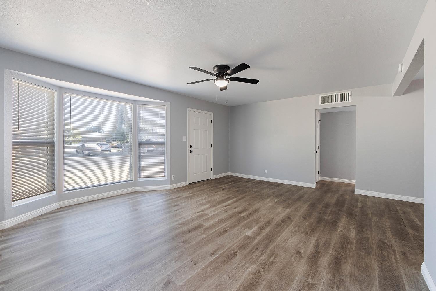 71 East Griffith Way Fresno, CA 93704 - Photo 8 of 35 a view of empty room with wooden floor and fan