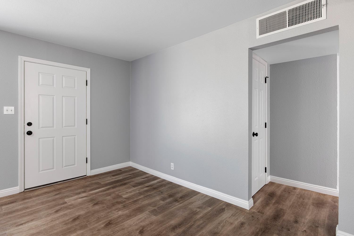 71 East Griffith Way Fresno, CA 93704 - Photo 9 of 35 a view of an empty room with wooden floor