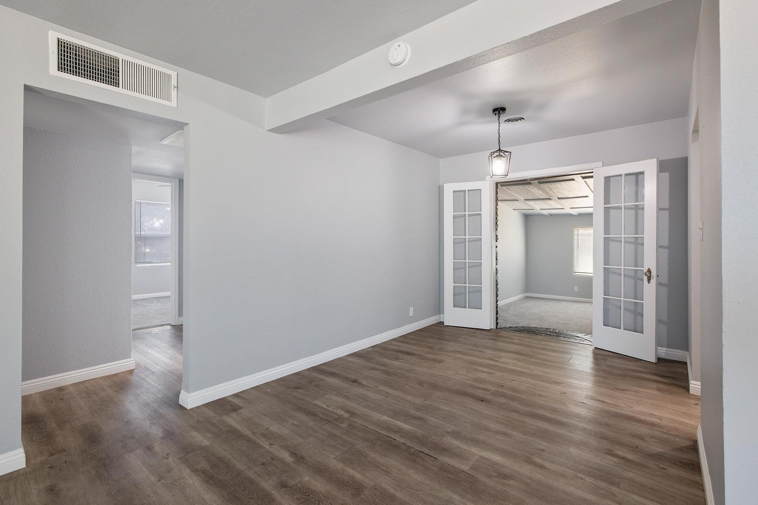 71 East Griffith Way Fresno, CA 93704 - Photo 10 of 35 an empty room with wooden floor closet and windows