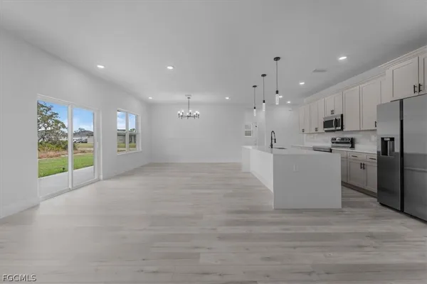a view of a kitchen with a sink and a refrigerator