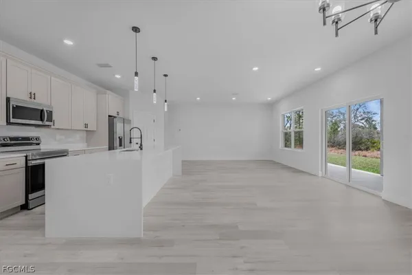 a view of a kitchen with microwave and cabinets