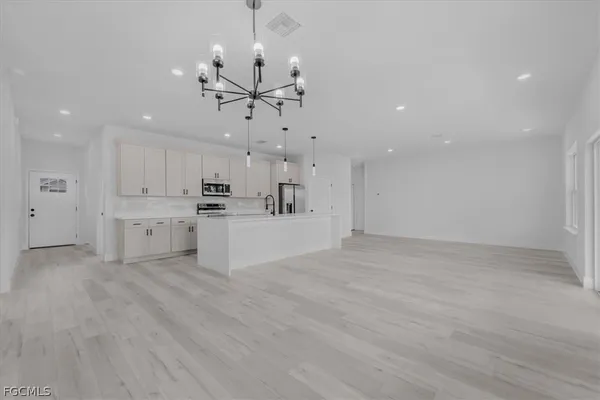 a view of a kitchen with a sink and microwave