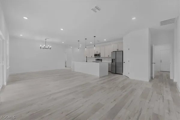 a view of a kitchen with a sink and a refrigerator
