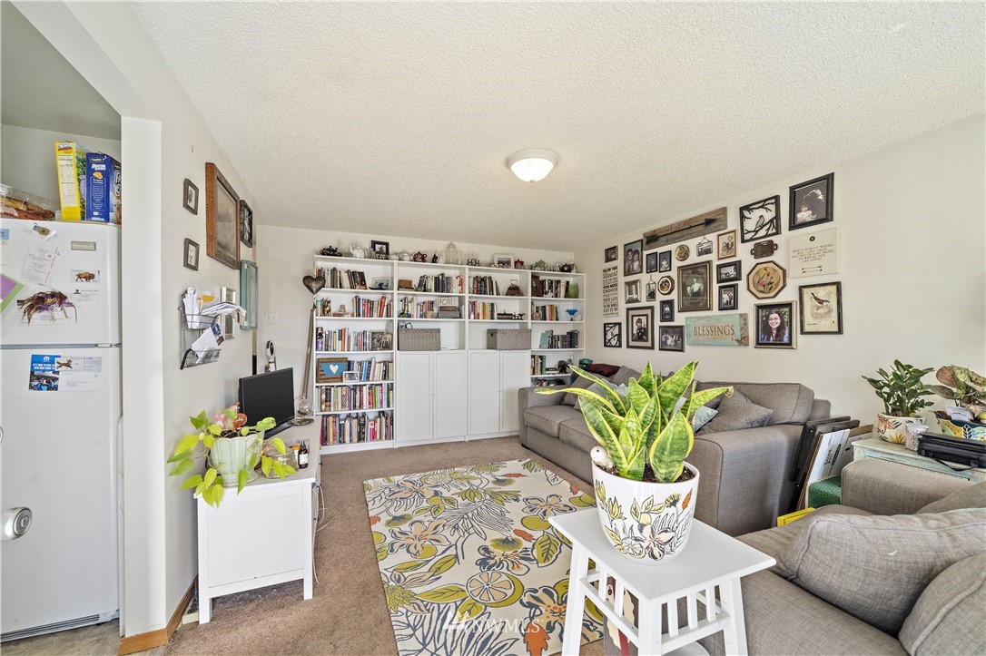 6028 Rockefeller Avenue Everett, WA 98203 - Photo 2 of 25 a living room with furniture and flowers