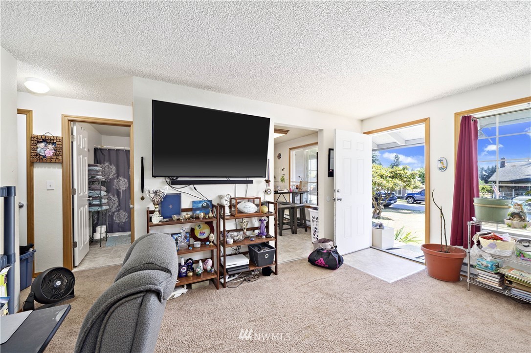 6028 Rockefeller Avenue Everett, WA 98203 - Photo 16 of 25 a living room with furniture and a flat screen tv