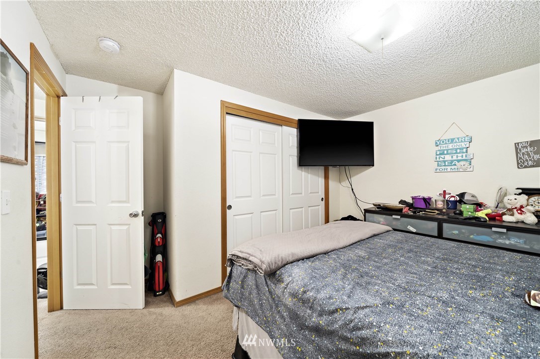 6028 Rockefeller Avenue Everett, WA 98203 - Photo 19 of 25 a bedroom with bed and a flat screen tv