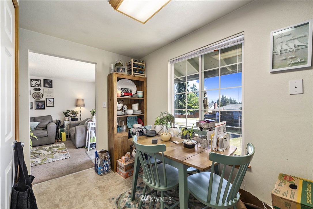 6028 Rockefeller Avenue Everett, WA 98203 - Photo 6 of 25 a view of a dining room with furniture and a window