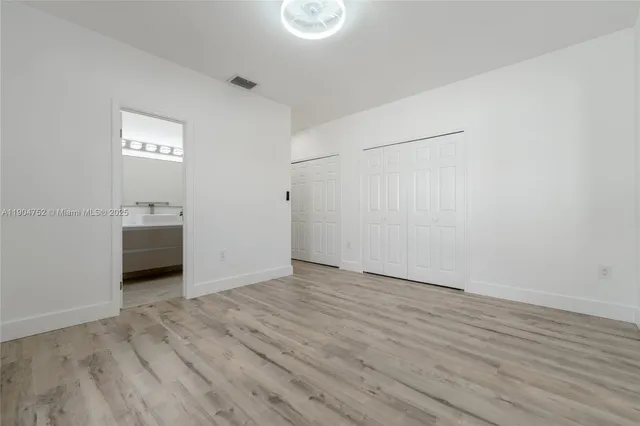 a bathroom with a sink toilet and mirror