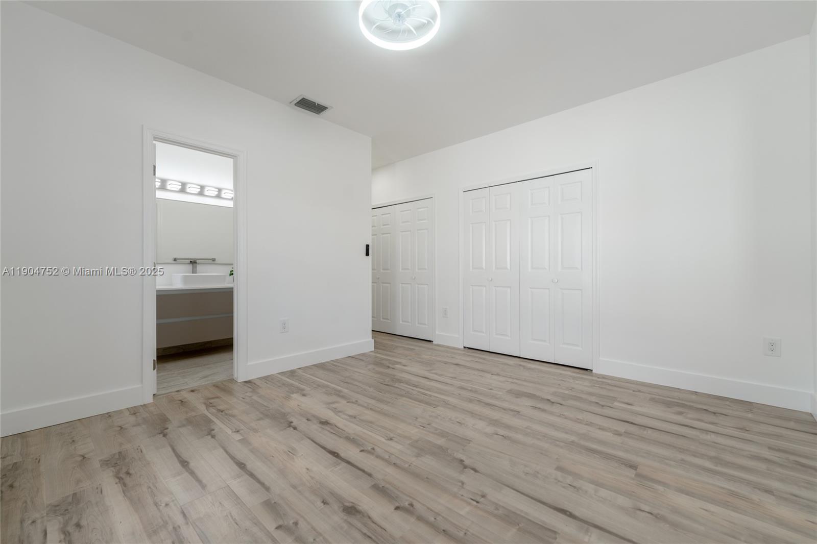 14231 Southwest 147th Place Miami, FL 33196 - Photo 20 of 35 a view of a hallway with wooden floor and closet