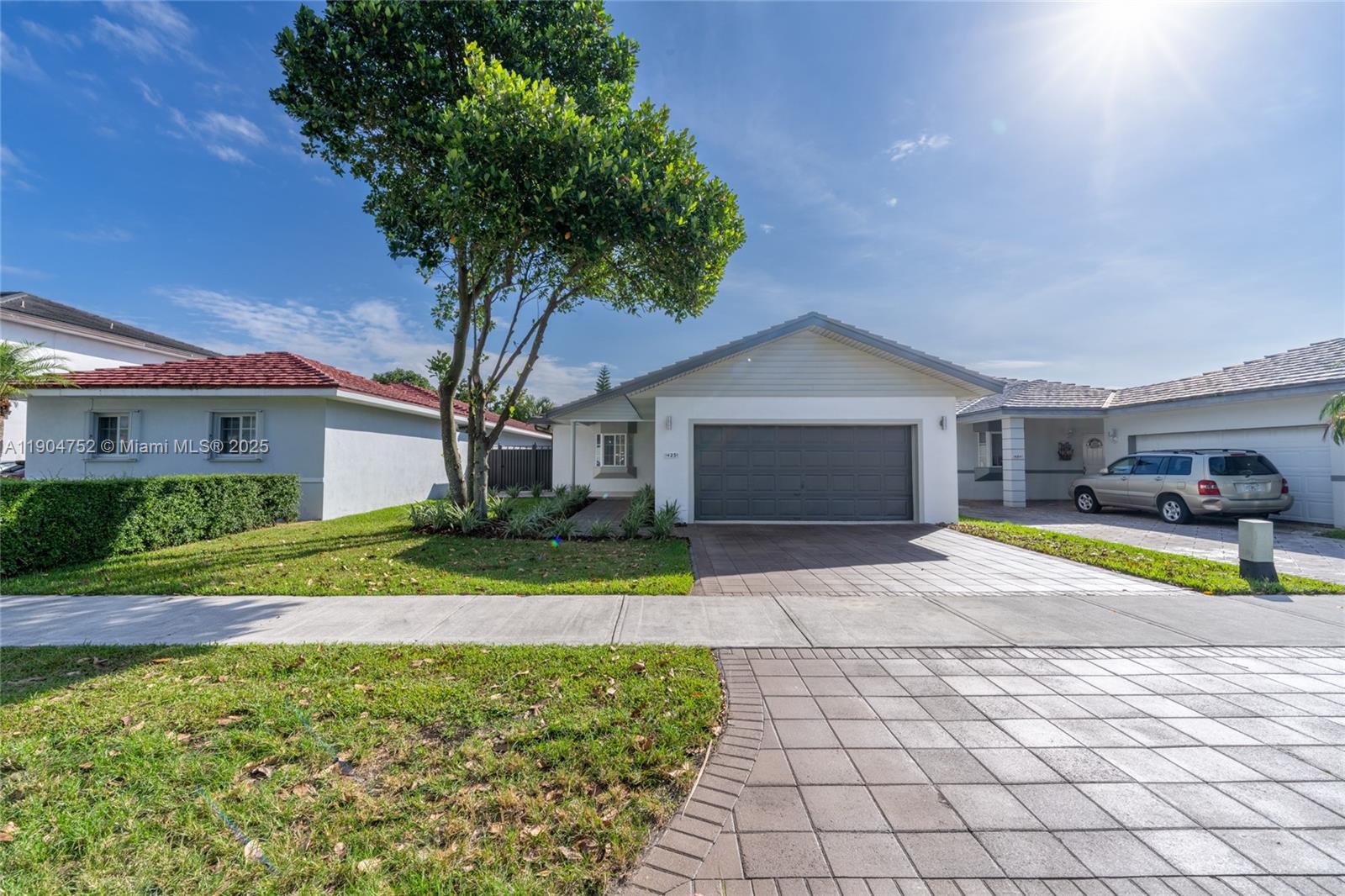 14231 Southwest 147th Place Miami, FL 33196 - Photo 2 of 35 a house view with a backyard space