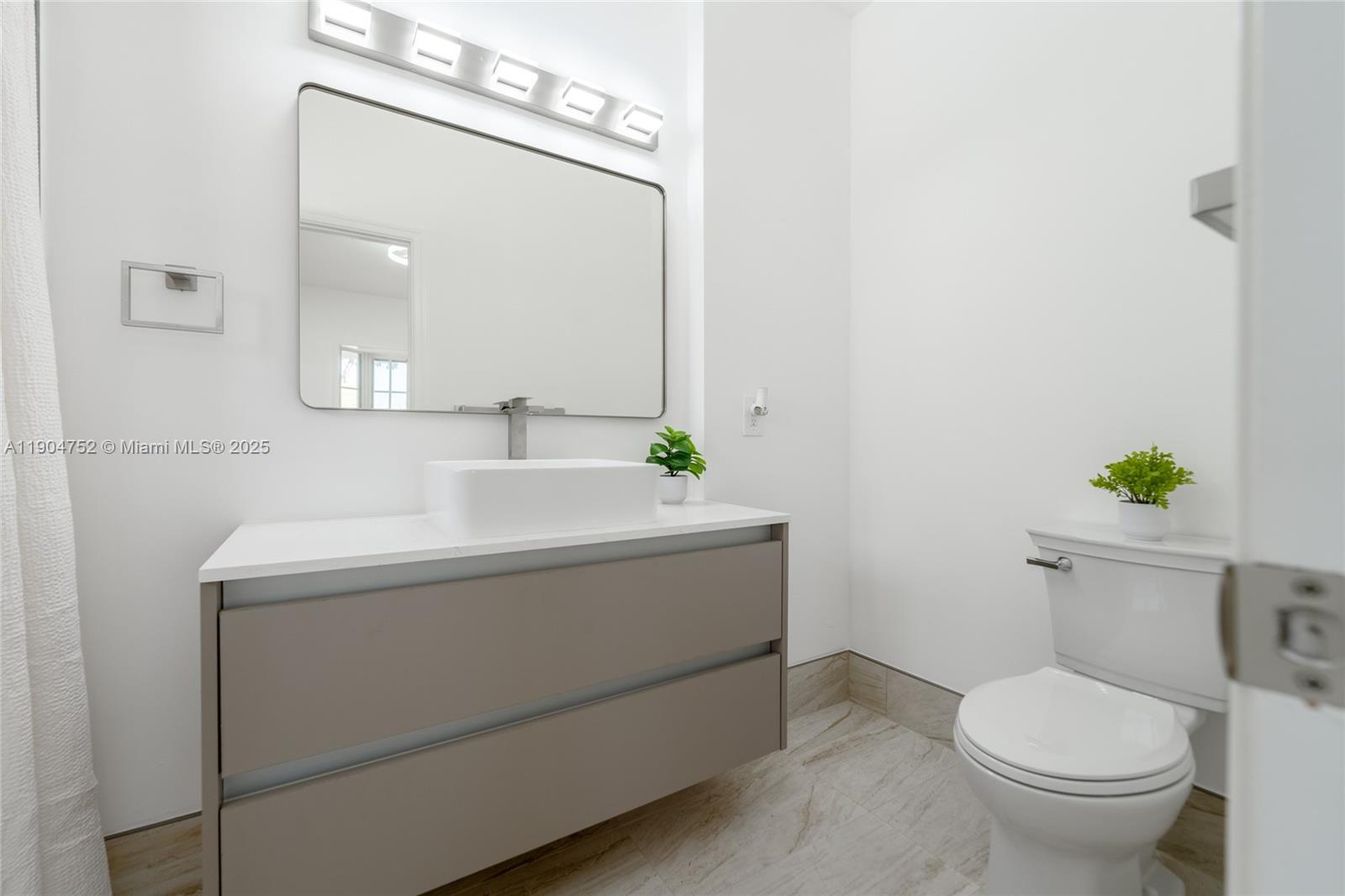 14231 Southwest 147th Place Miami, FL 33196 - Photo 21 of 35 a bathroom with a sink toilet and mirror