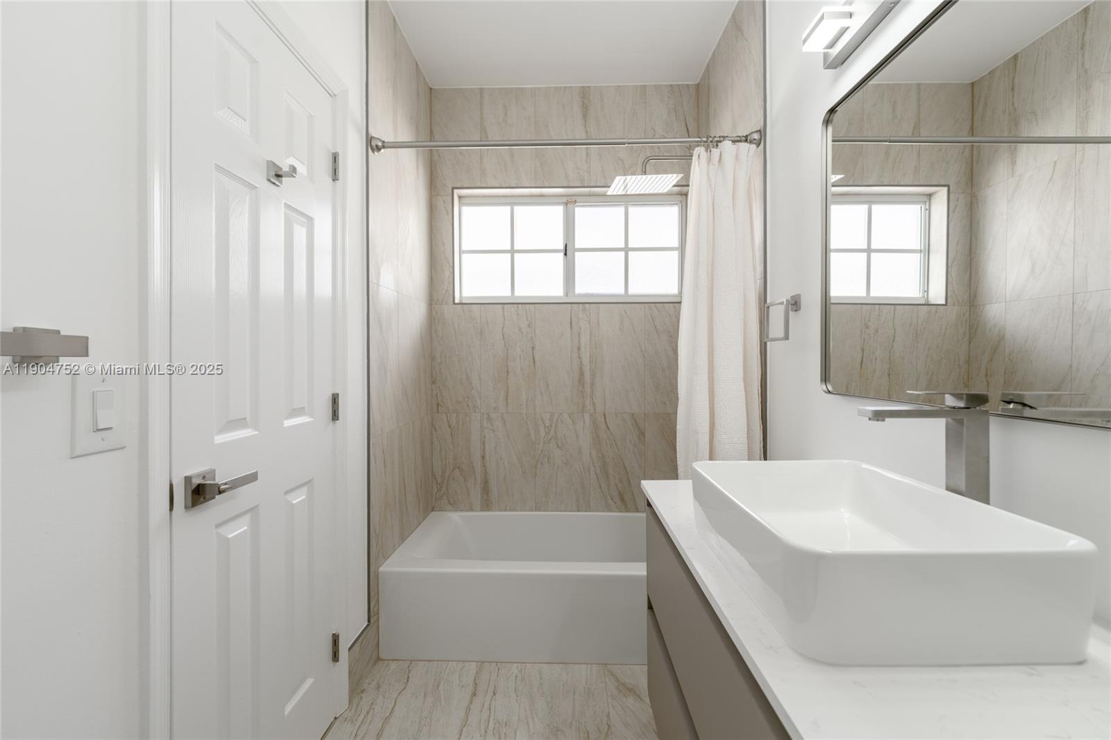 14231 Southwest 147th Place Miami, FL 33196 - Photo 22 of 35 a bathroom with a bathtub a shower a sink and a toilet