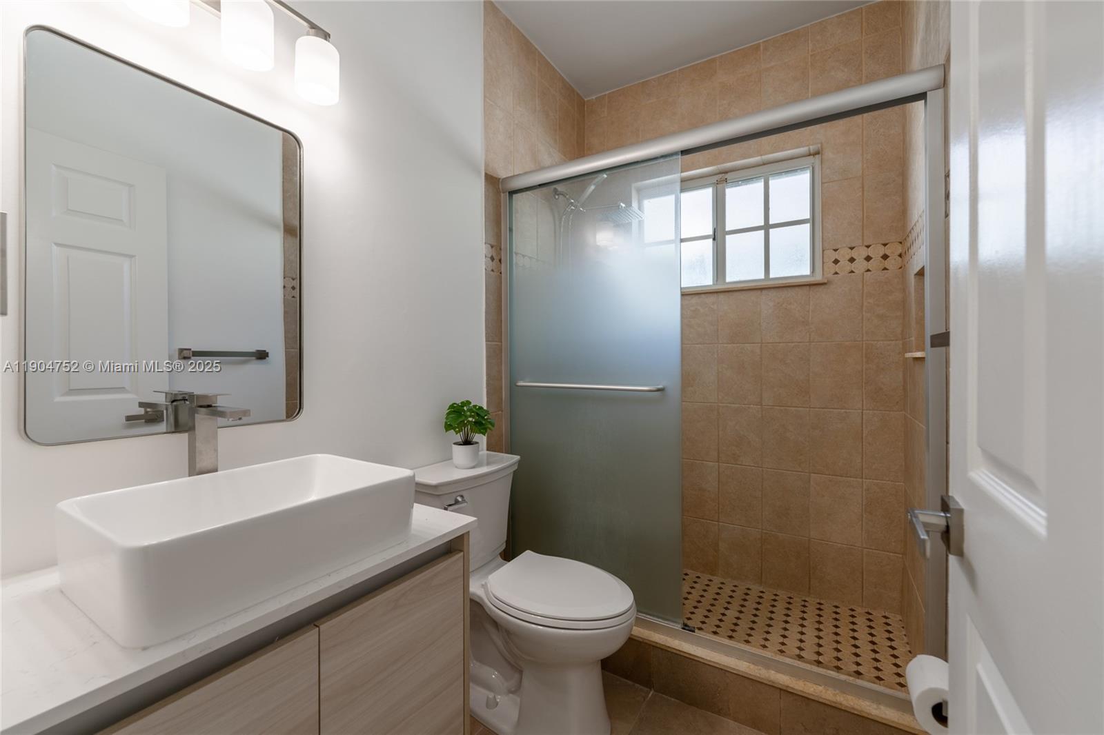 14231 Southwest 147th Place Miami, FL 33196 - Photo 27 of 35 a bathroom with a sink toilet and shower