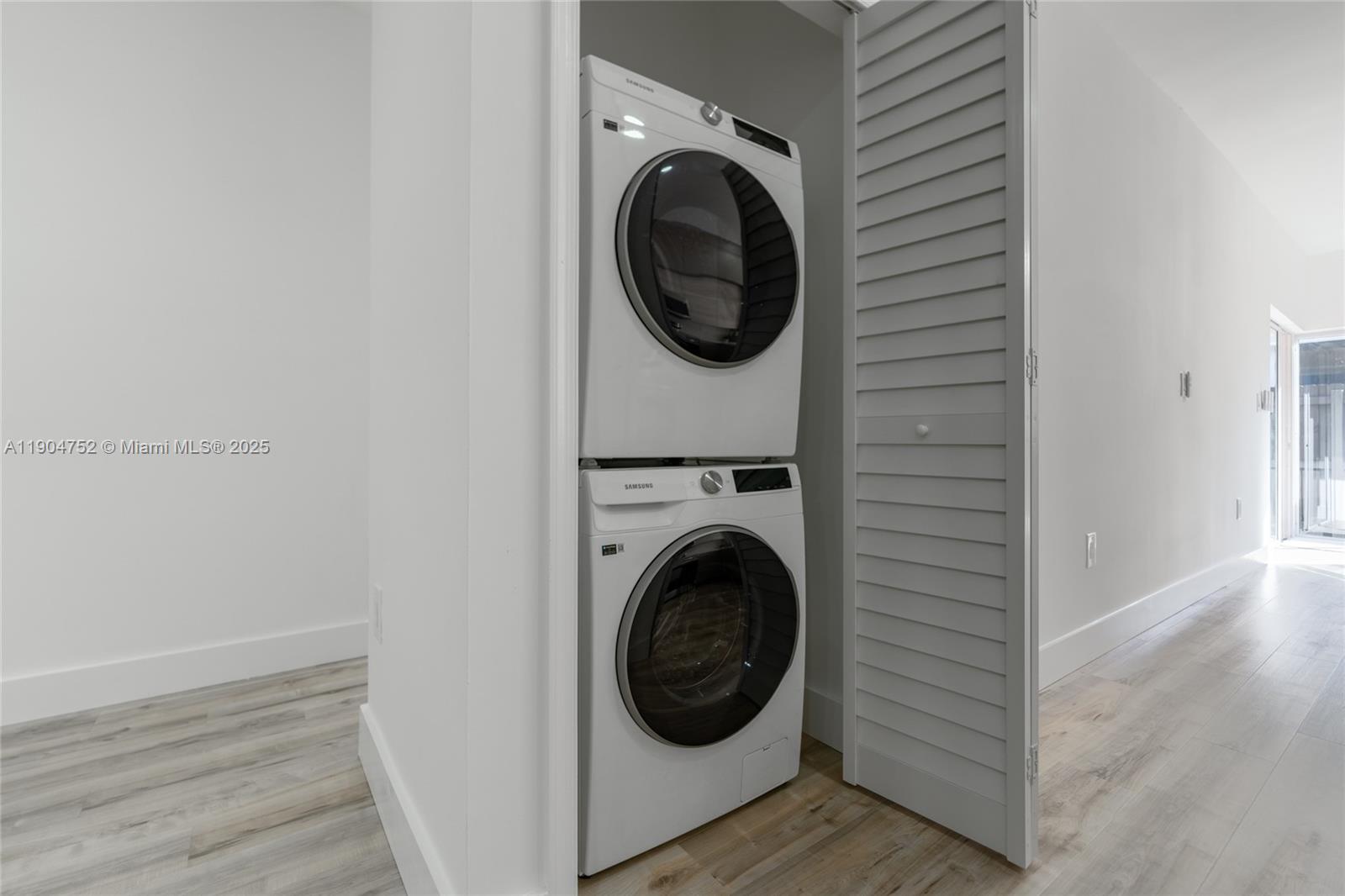 14231 Southwest 147th Place Miami, FL 33196 - Photo 28 of 35 a view of a hallway with washer and dryer