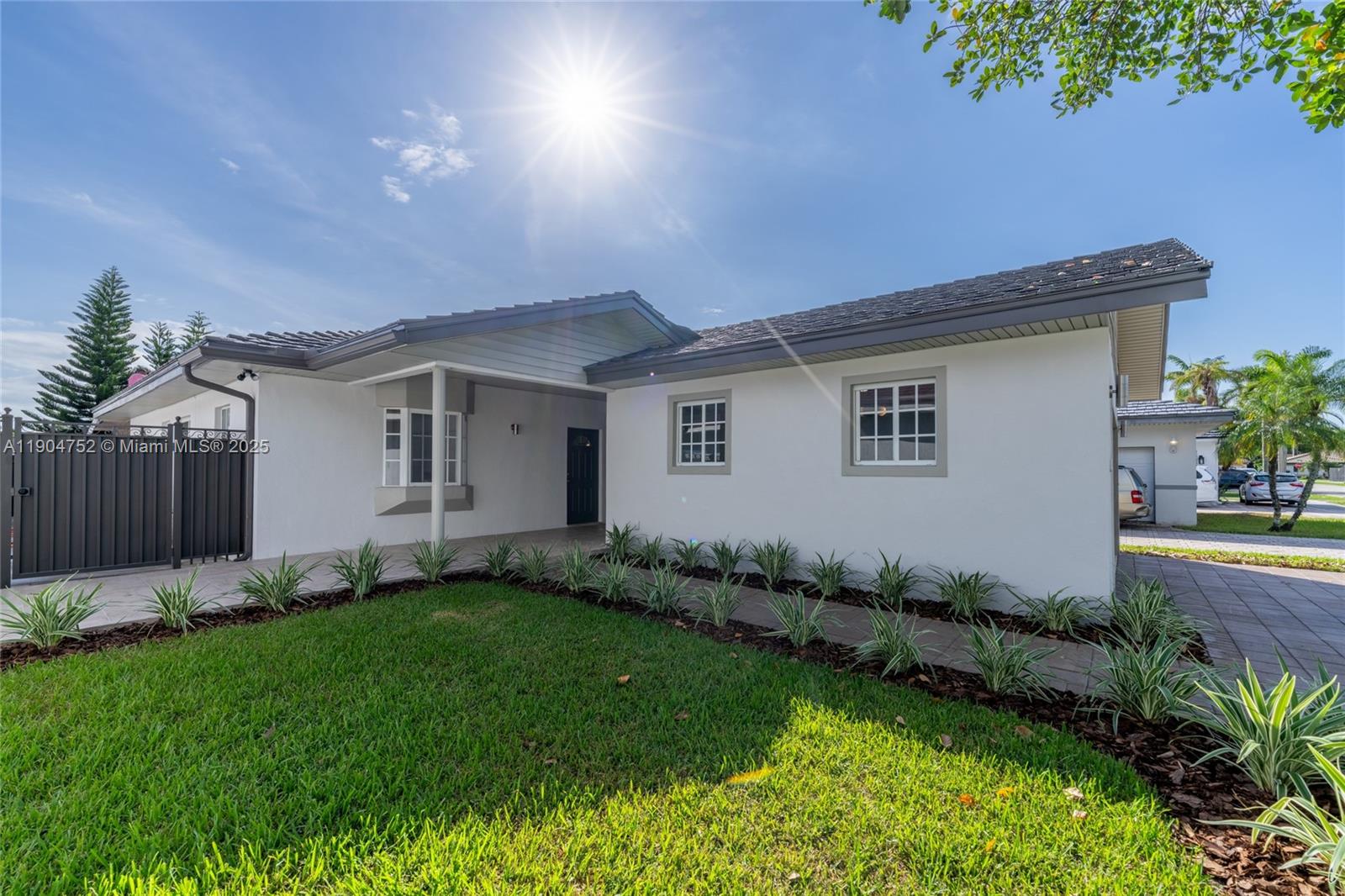 14231 Southwest 147th Place Miami, FL 33196 - Photo 3 of 35 a front view of a house with a garden and yard
