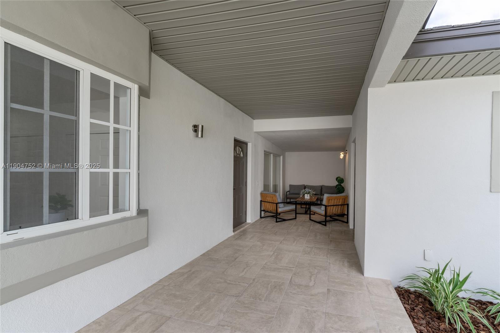 14231 Southwest 147th Place Miami, FL 33196 - Photo 5 of 35 a view of a house with a large window and sitting area