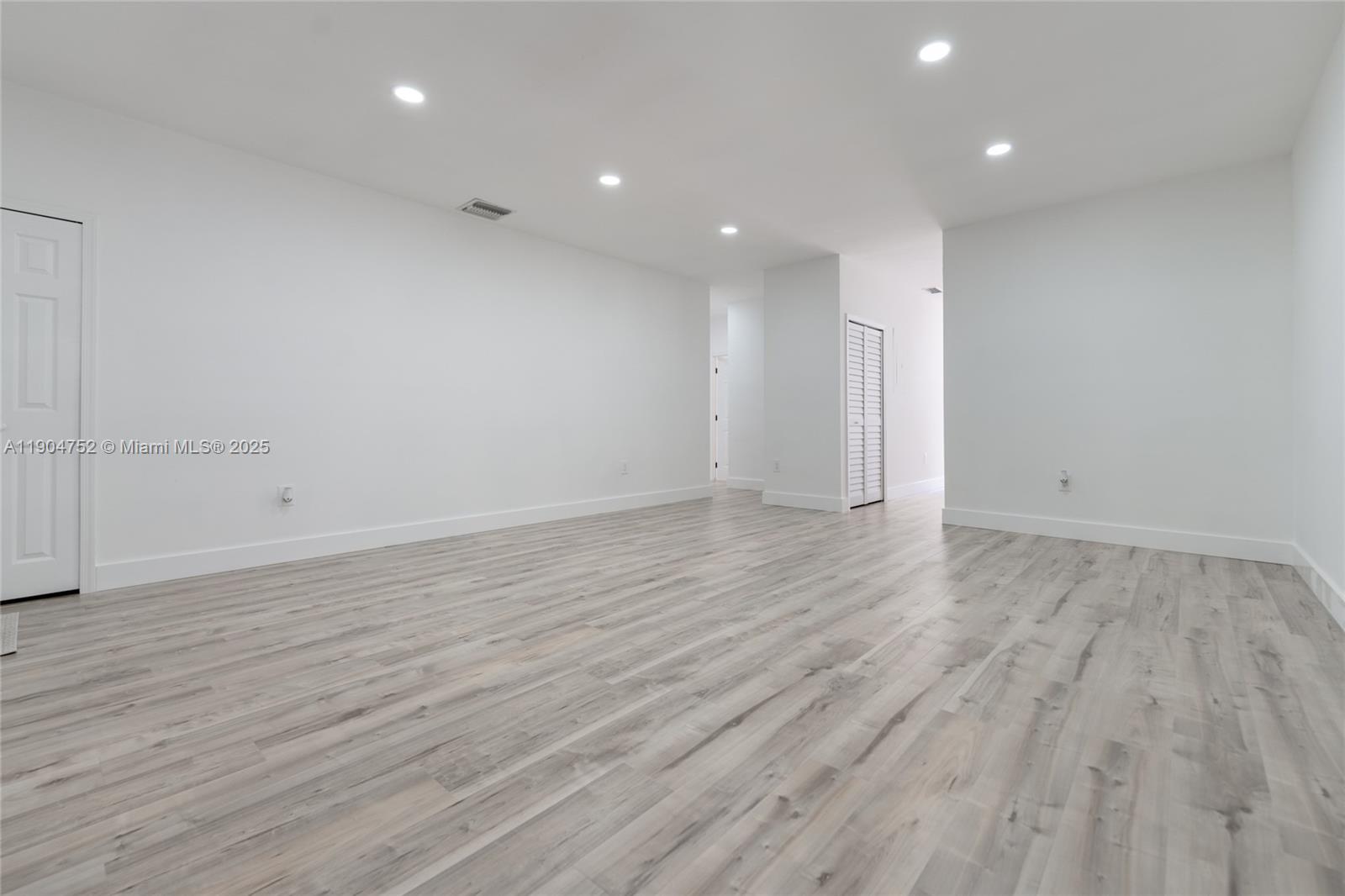 14231 Southwest 147th Place Miami, FL 33196 - Photo 7 of 35 an empty room with wooden floor and windows