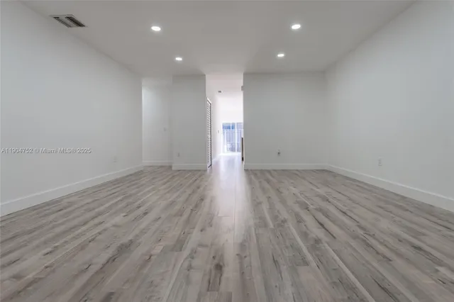 a view of room with wooden floor and window