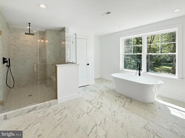 a bathroom with a bathtub and a shower