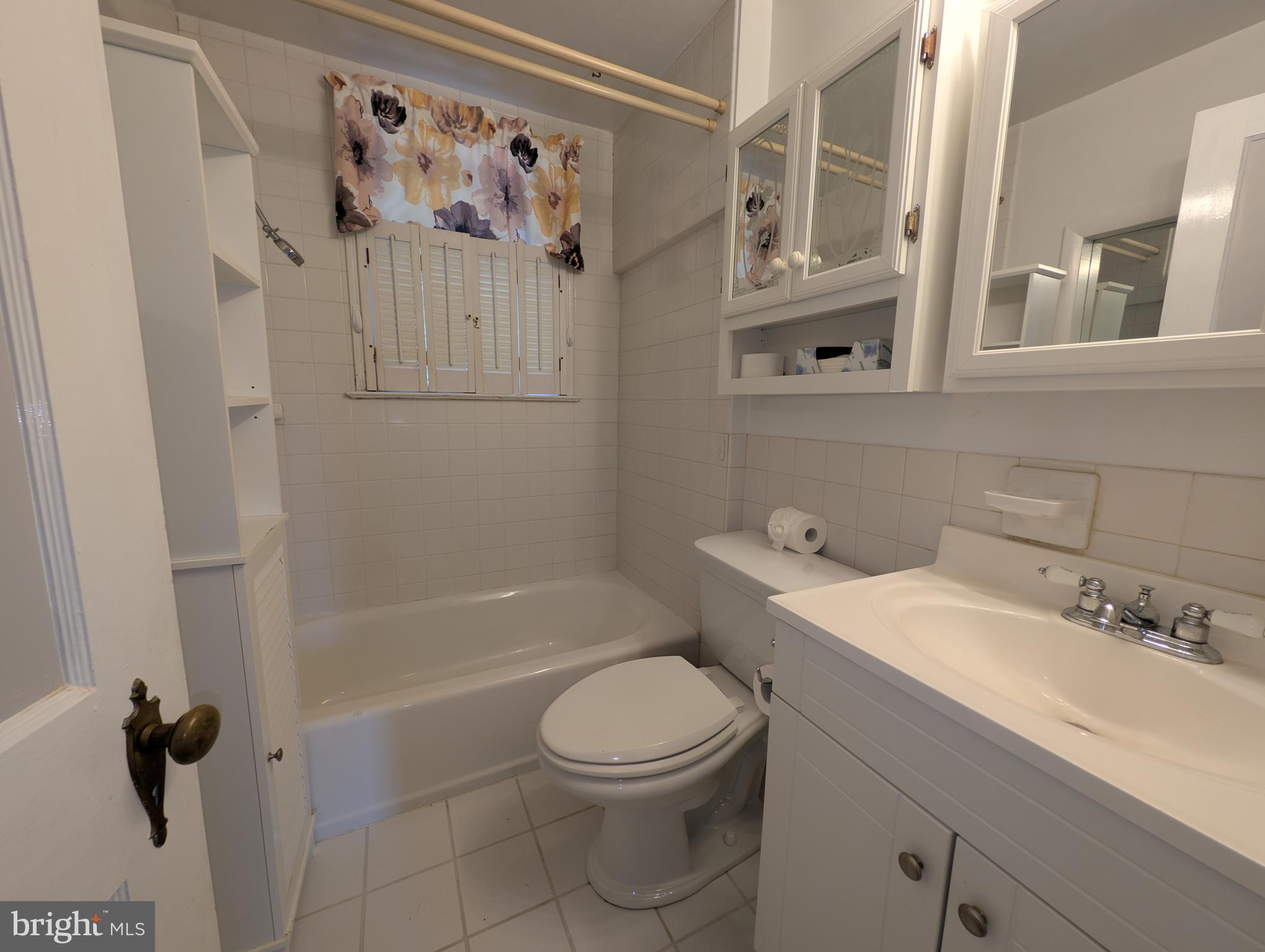 1129 Providence Road Springfield, PA 19064 - Photo 9 of 15 a bathroom with a sink a toilet and shower