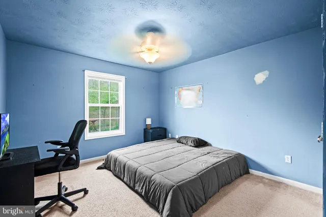 a bedroom with a bed and a desk