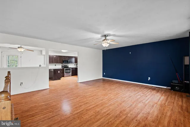a view of kitchen with livingroom and wooden floor