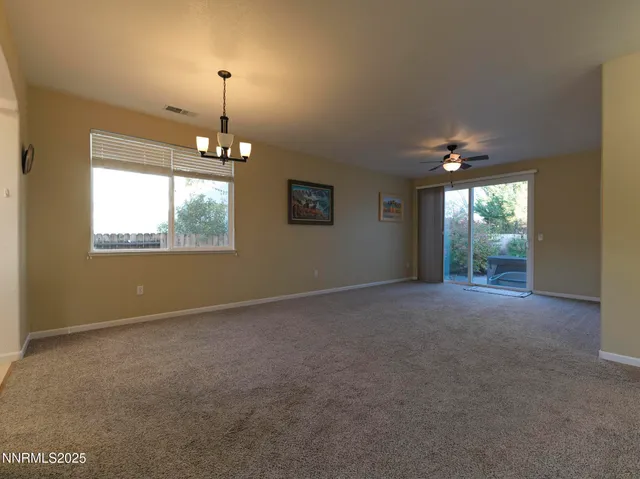 an empty room with windows and outdoor view