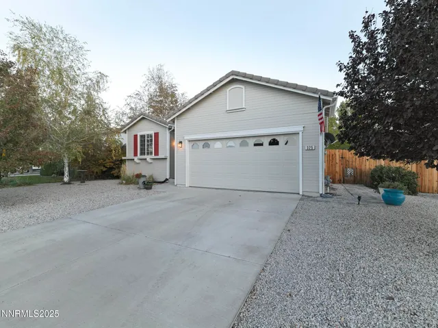 a view of garage and wooden fence