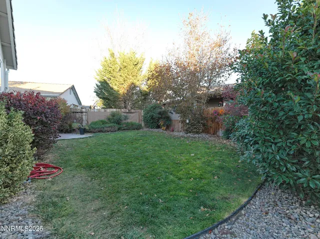 a backyard of a house with table and chairs