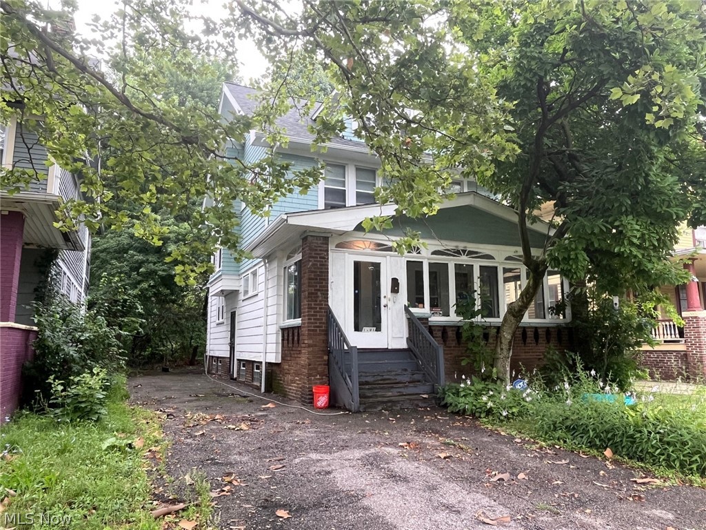 1101 Carlyon Road East Cleveland, OH 44112 - Photo 23 of 23 Two-story dwelling with a covered front porch and mature trees