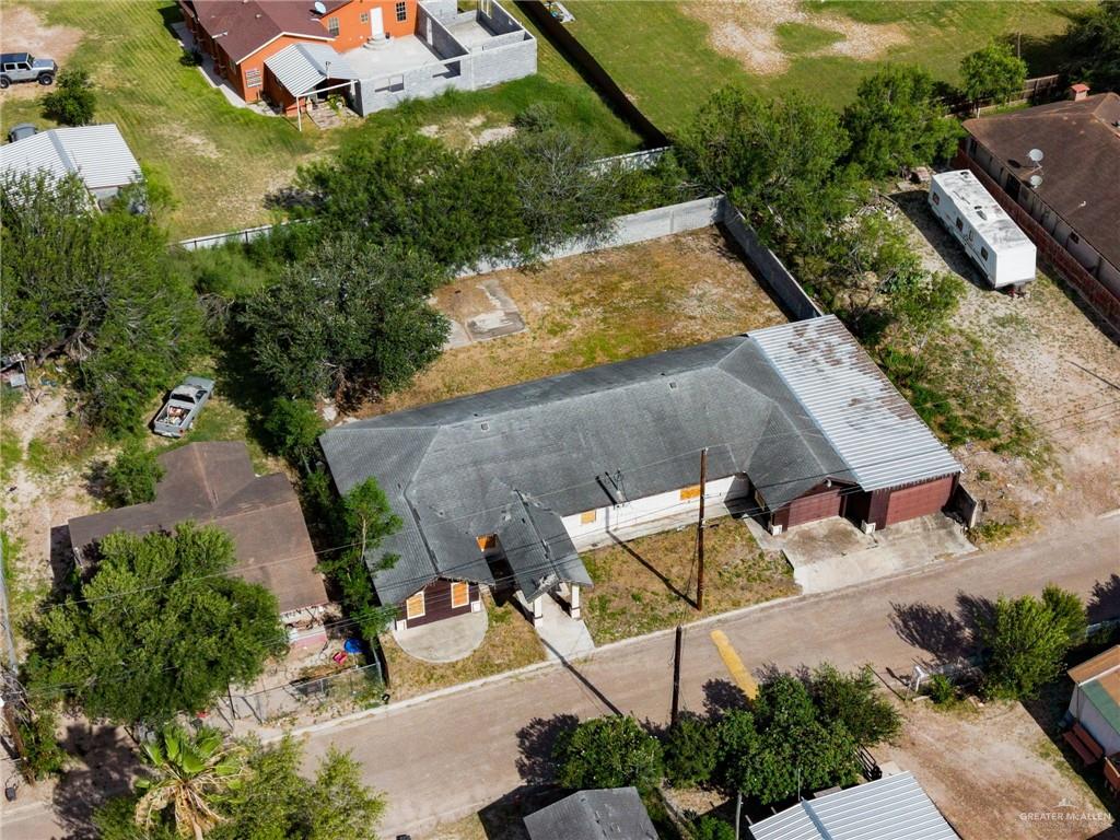 879 Austin Road Roma, TX 78584 - Photo 5 of 7 Property featuring a multi-gabled roofline, a detached garage with two bays, and a concrete driveway