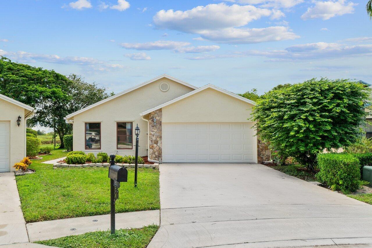 a view of a house with a yard and plants