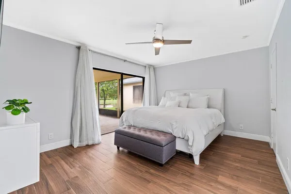 a spacious bedroom with a bed and a window