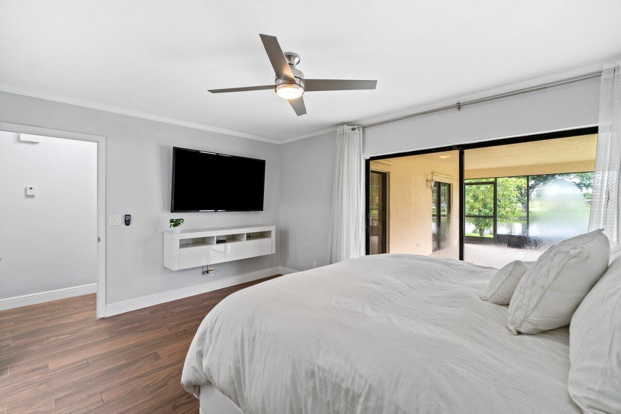 19977 Villa Medici Place Boca Raton, FL 33434 - Photo 16 of 33 a bedroom with a bed tv and a large window