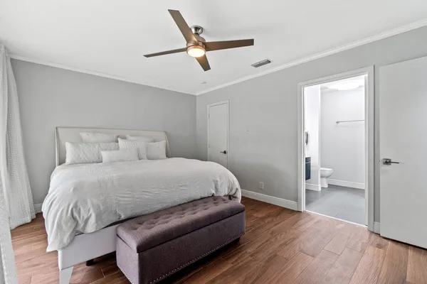 a bedroom with a bed and a ceiling fan