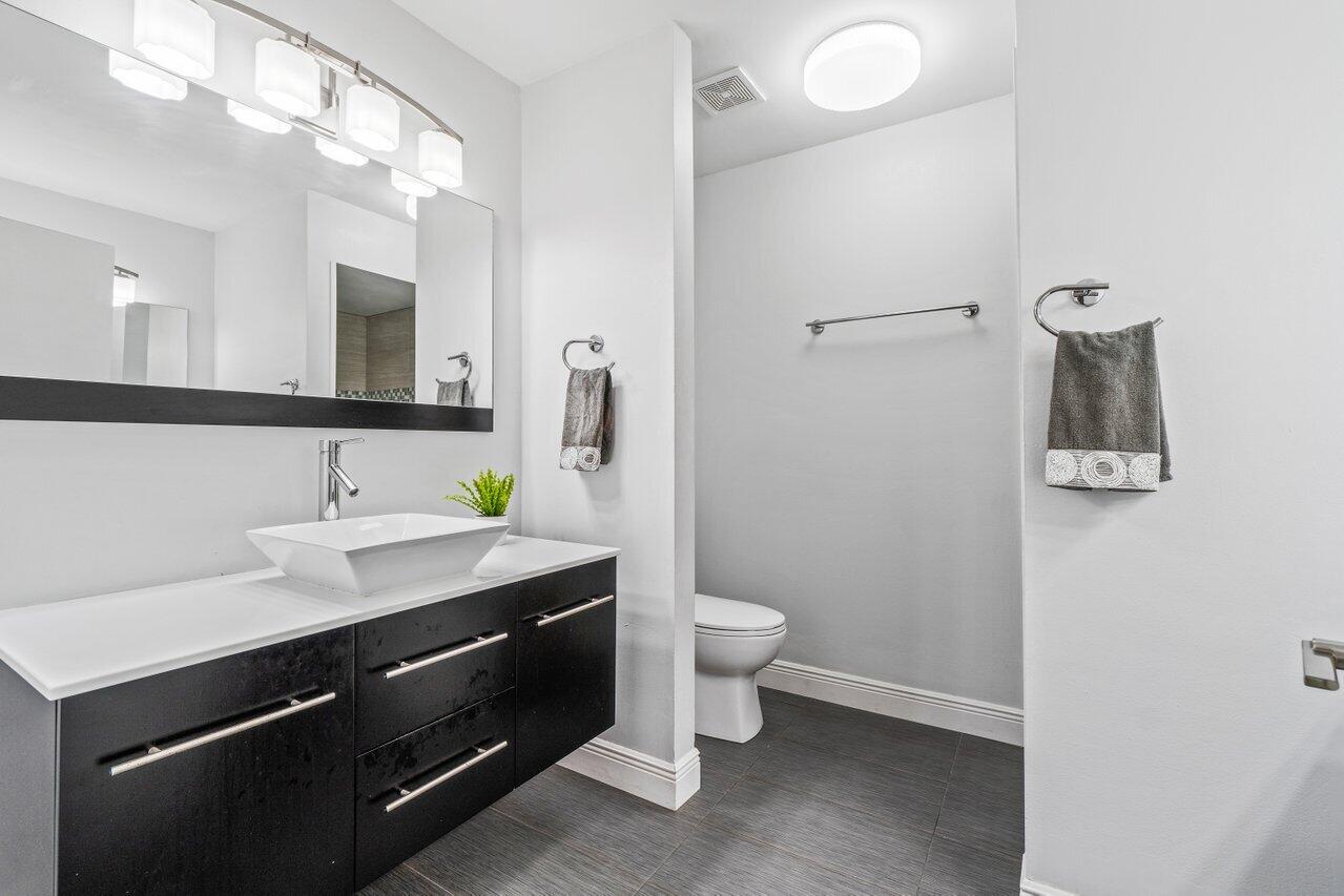19977 Villa Medici Place Boca Raton, FL 33434 - Photo 18 of 33 a bathroom with a sink and a mirror