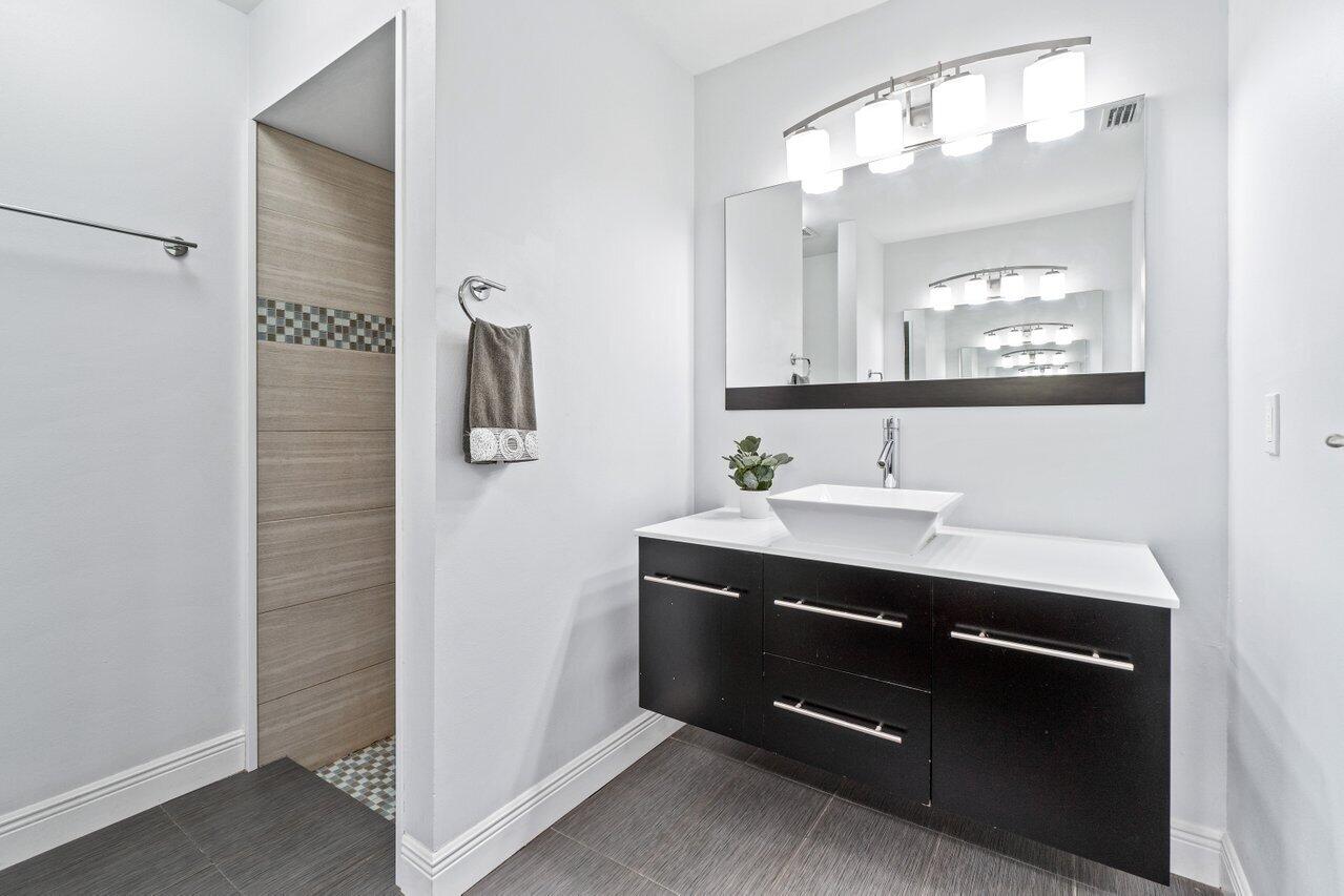19977 Villa Medici Place Boca Raton, FL 33434 - Photo 19 of 33 a bathroom with a sink and a mirror